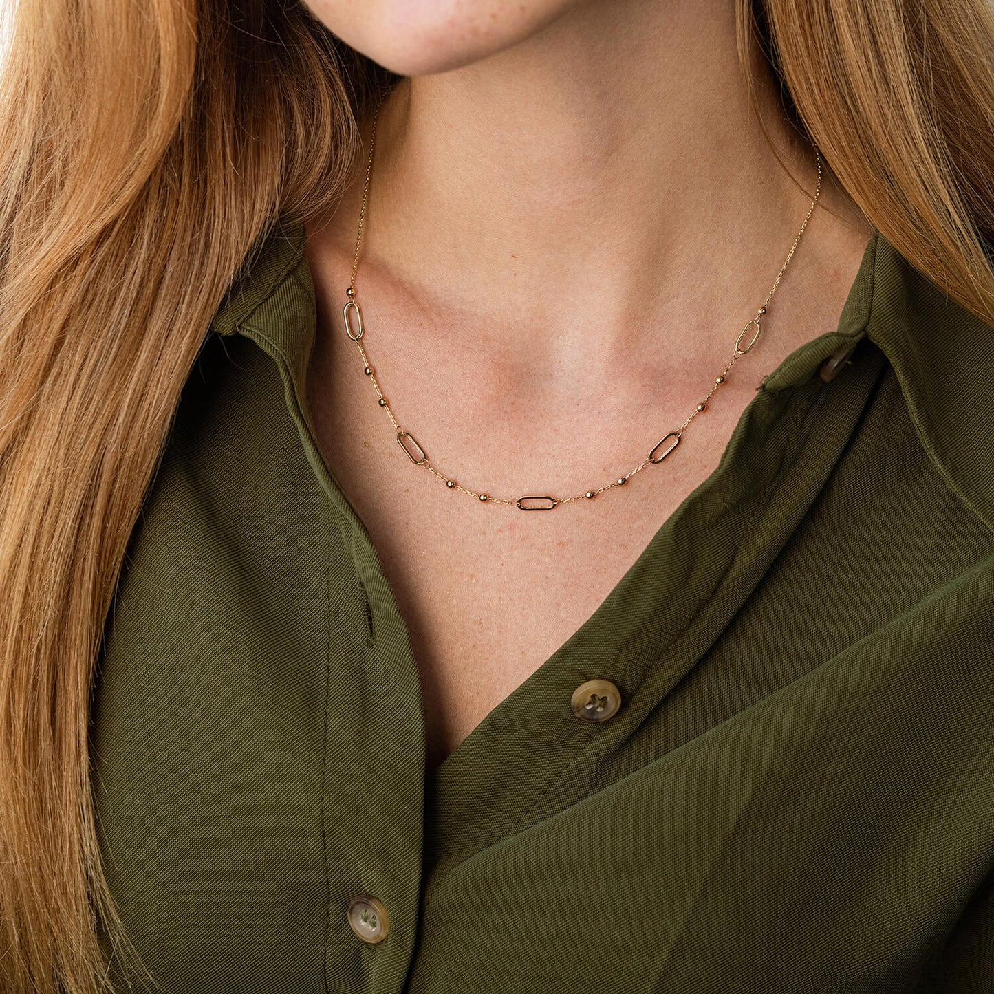 Close-up of a person wearing a gold necklace-Perfect for gifting necklace