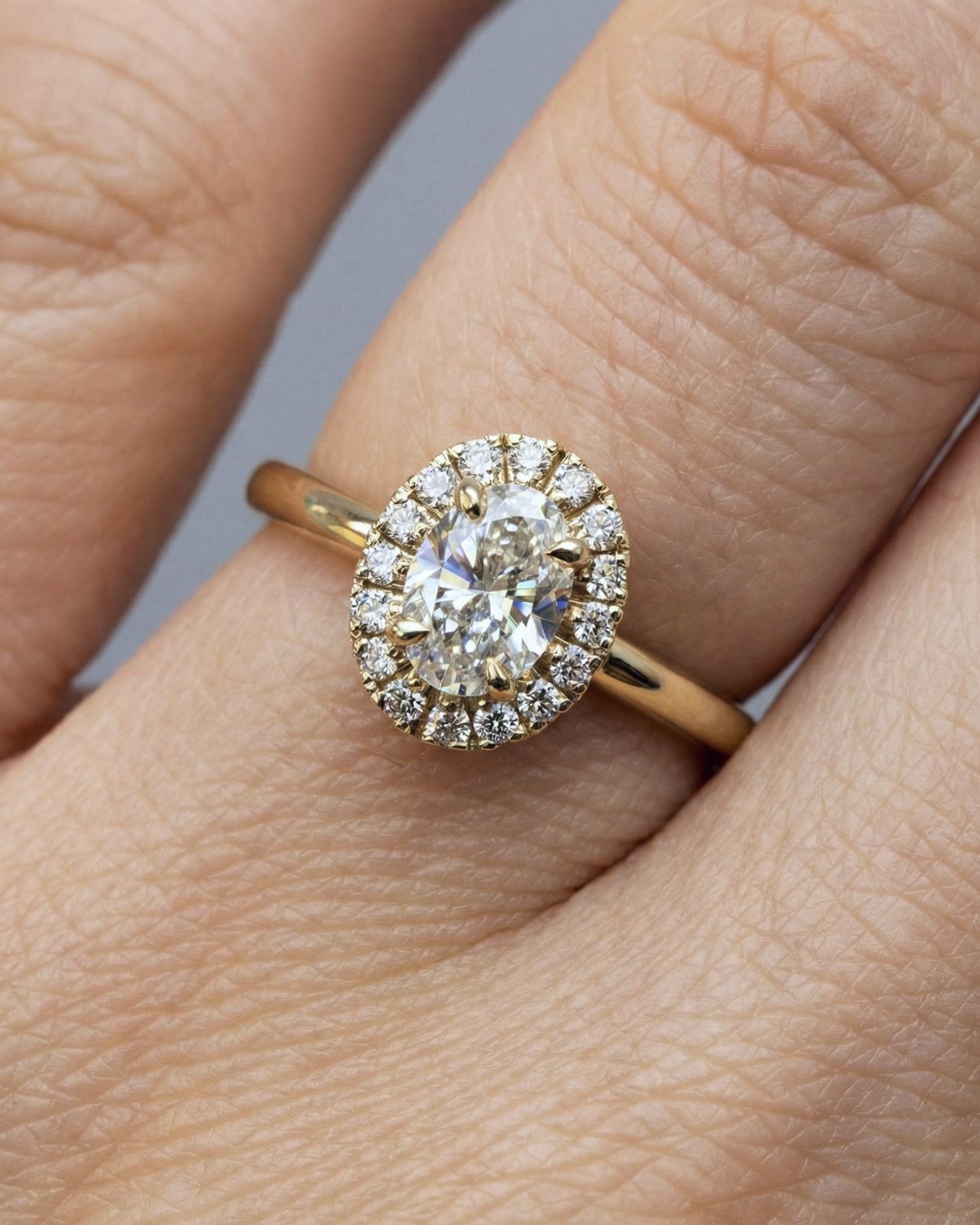 engagement ring wrapped in a soft halo of pavé diamonds-center stone: 0.5 ct oval lab diamond VVS2/D- total diamond weight: 0.66 ct