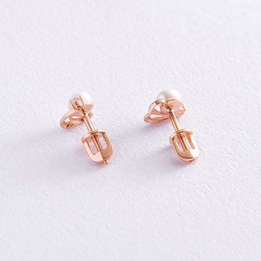 A pair of rose gold stud earrings with a small white pearl-delicate pearl earrings
dainty pearl earrings-minimalist gold earrings