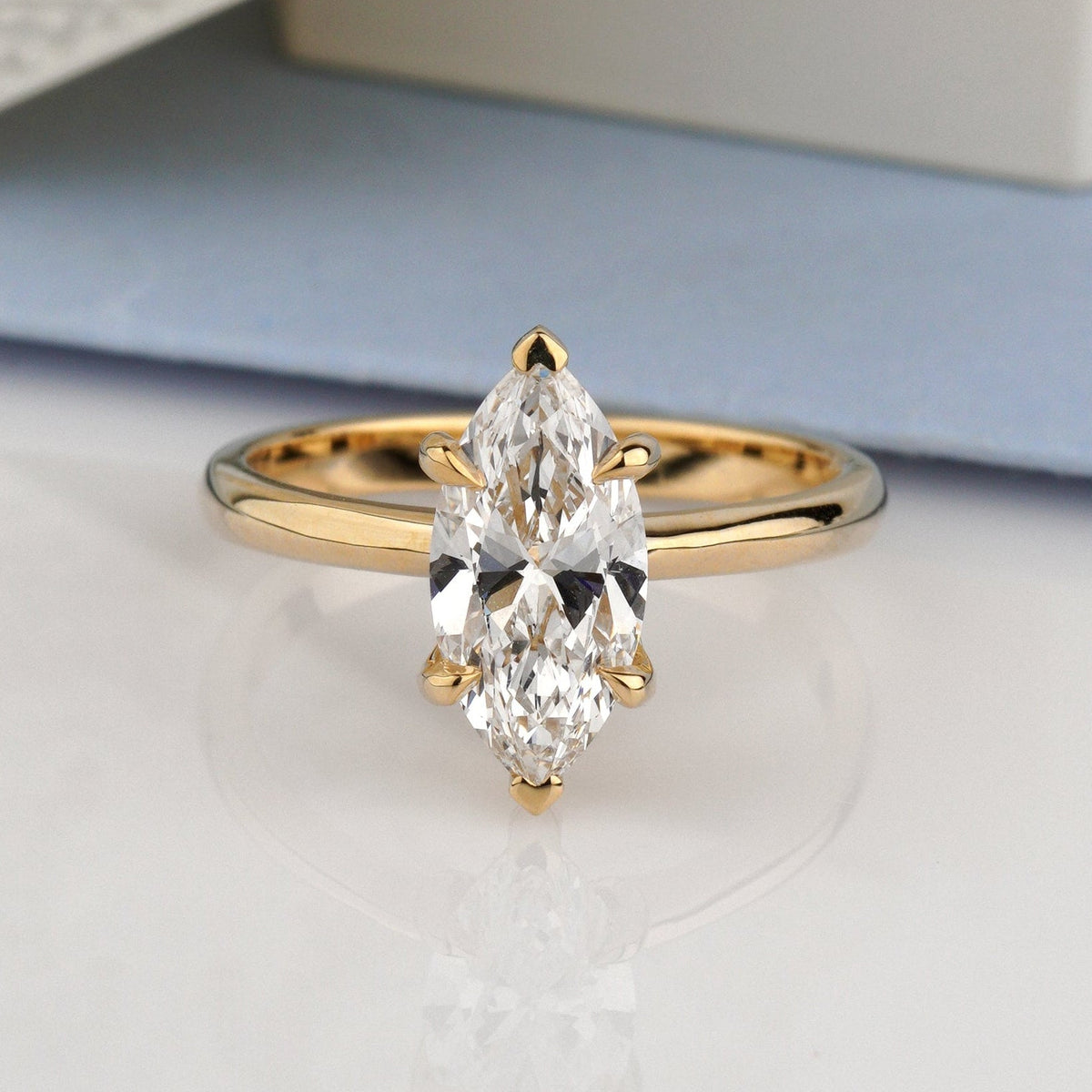 A gold ring with a marquise-cut clear gemstone-marquise diamond ring
lab grown diamond ring
14k gold engagement ring