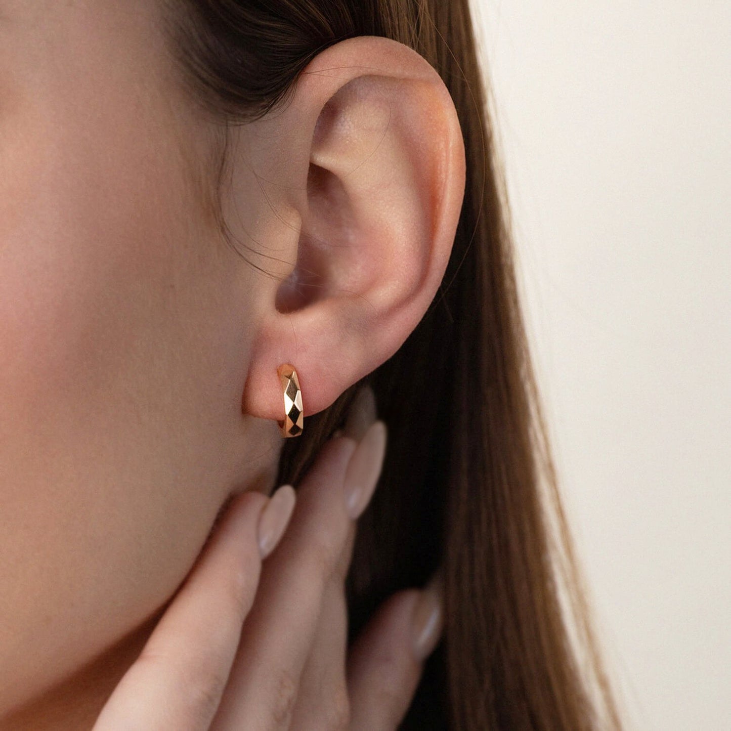 Close-up of an ear wearing a gold hoop earring -Gold Hoop Earrings-Huggie gold earrings