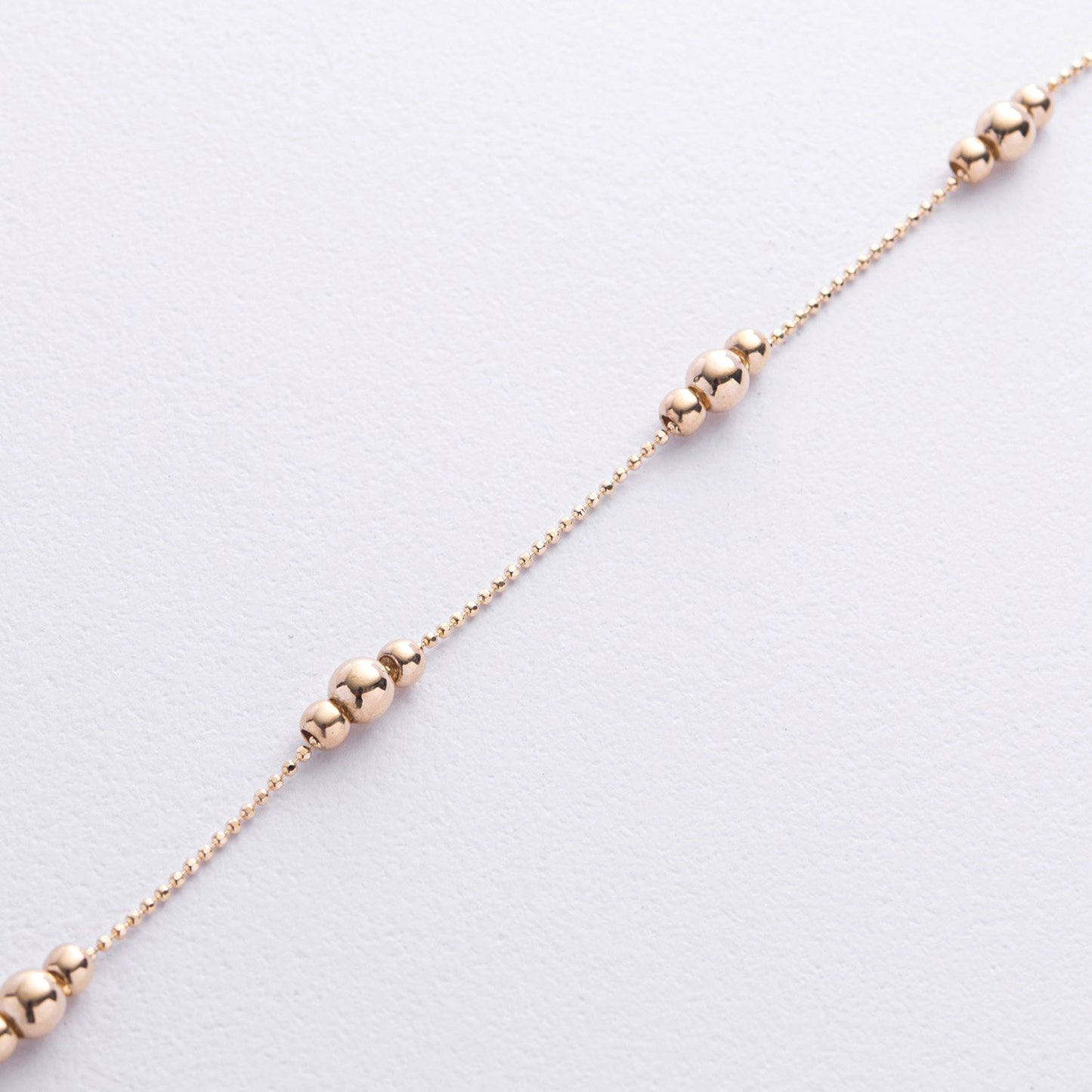 A delicate rose gold chain bracelet featuring three polished bead clusters spaced along the chain-minimalist gold bracelet-delicate gold bead bracelet-dainty gold chain bracelet