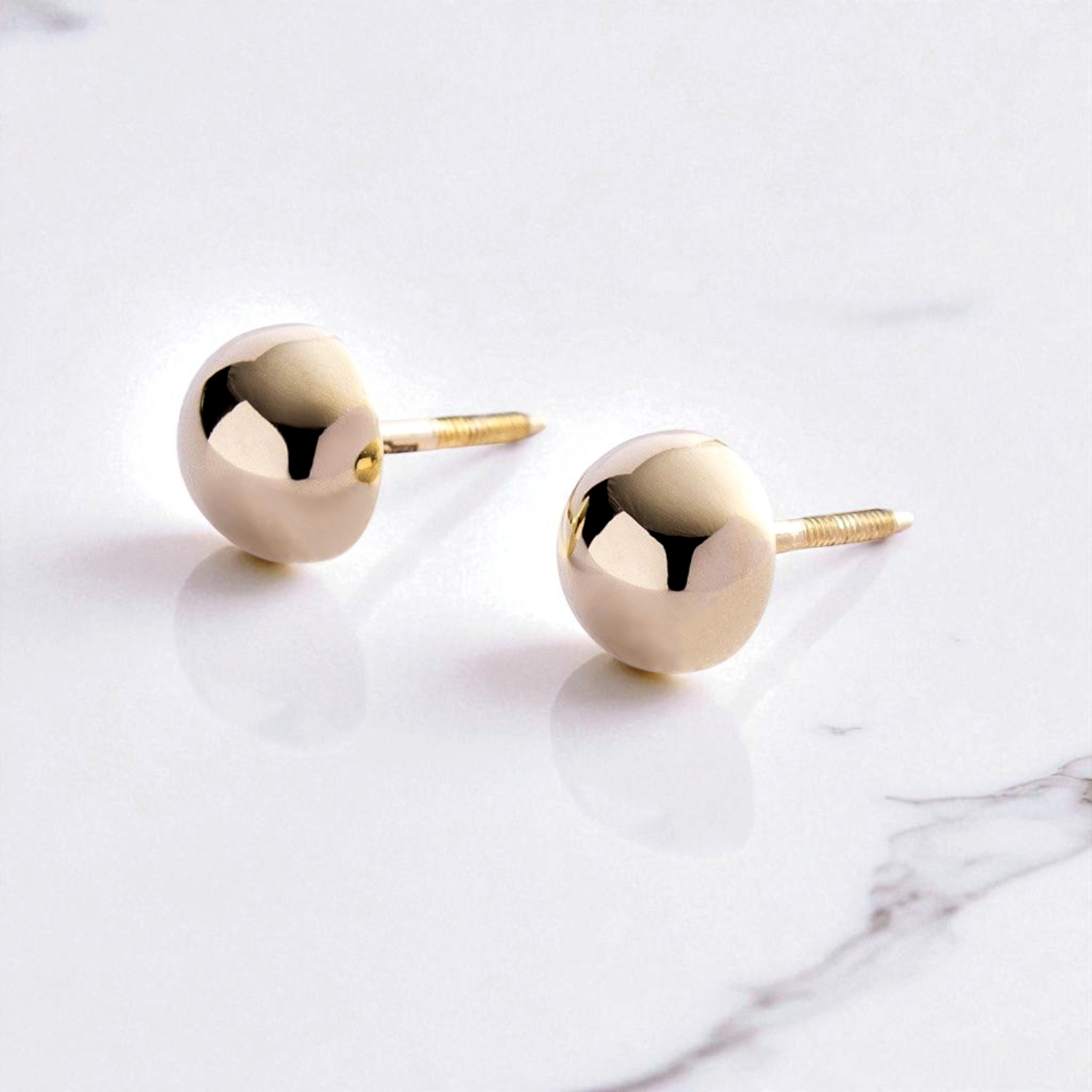 7mm gold ball earrings-Flat lay of delicate gold ball stud earrings , 14k gold 585