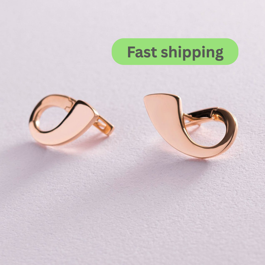 A pair of rose gold crescent-shaped hoop earrings on a light gray textured background with a green 'Fast shipping' label overlay-Material: 14k (585) solid rose gold-Earring height: 2.2 cm