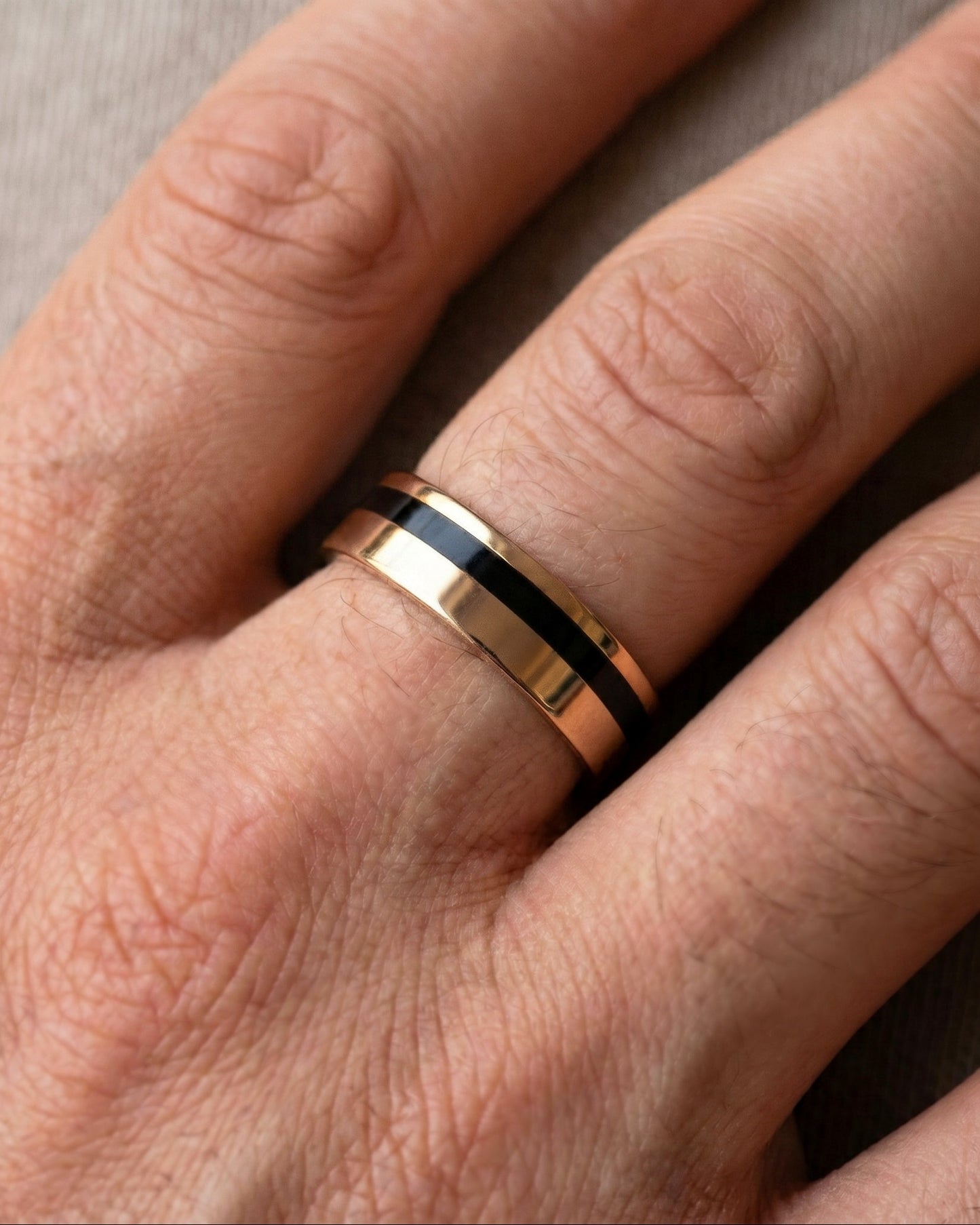 Black_and_Gold_wedding band on Mens  hand - escorial jewelry