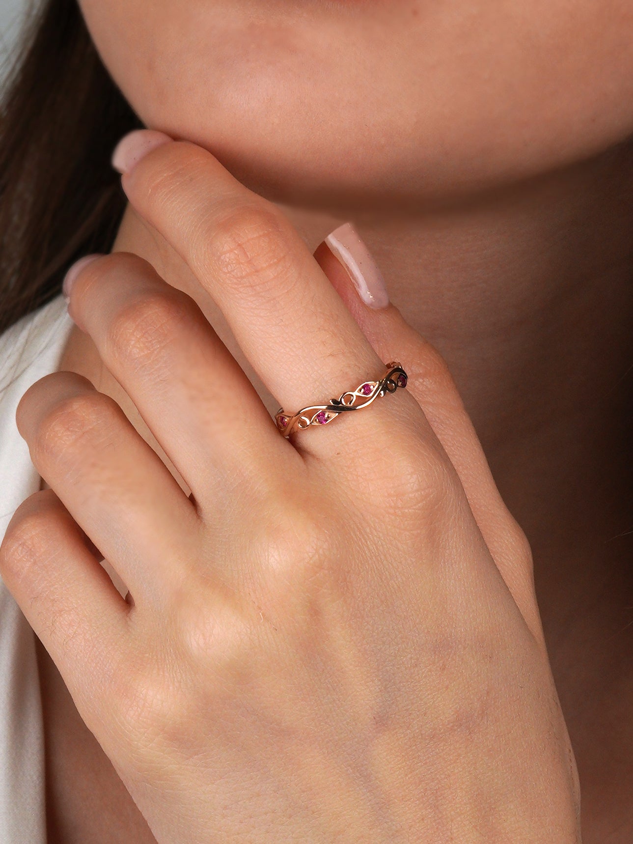 Close-up of a hand wearing a delicate ring with intricate design-Stacking ruby band-Dainty gold ring