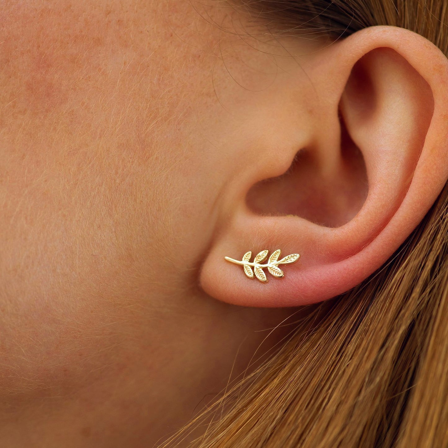 Gold leaf earring worn on a person's ear-Dainty Everyday earrings-solid gold earrings