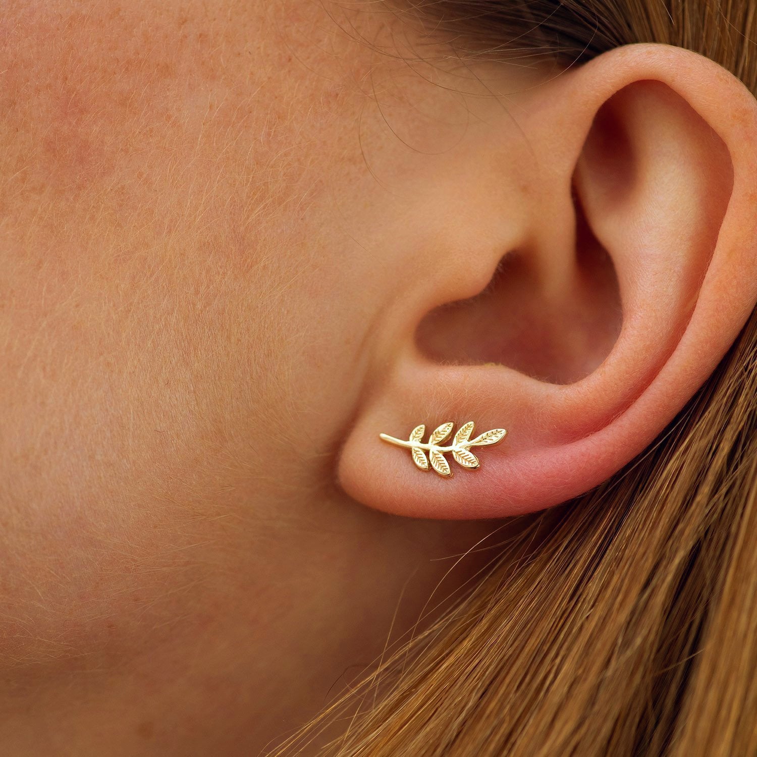 Gold leaf earring worn on a person's ear-Dainty Everyday earrings-solid gold earrings