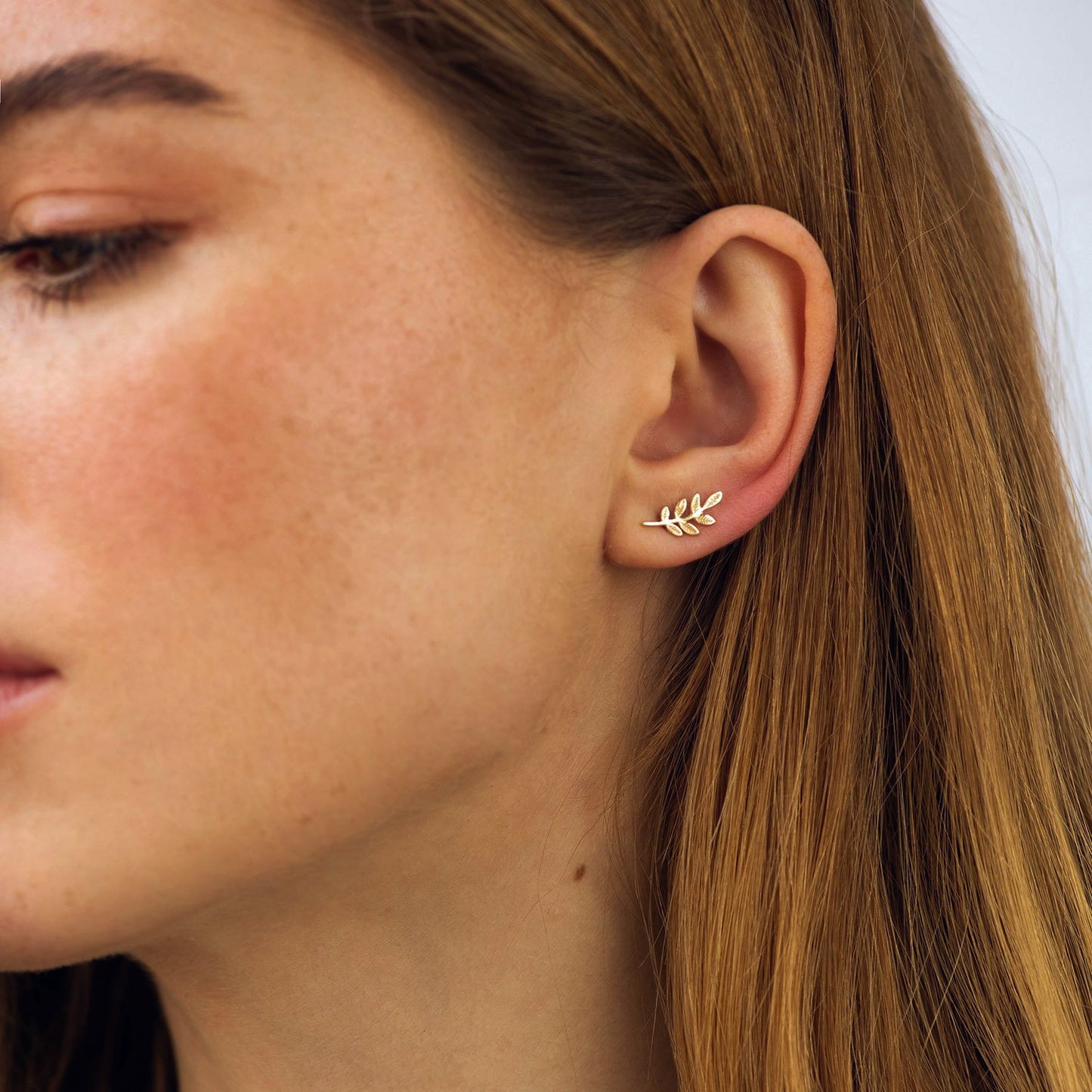Close-up of a person wearing a gold leaf earring-solid gold earrings-Size: 13*6mm