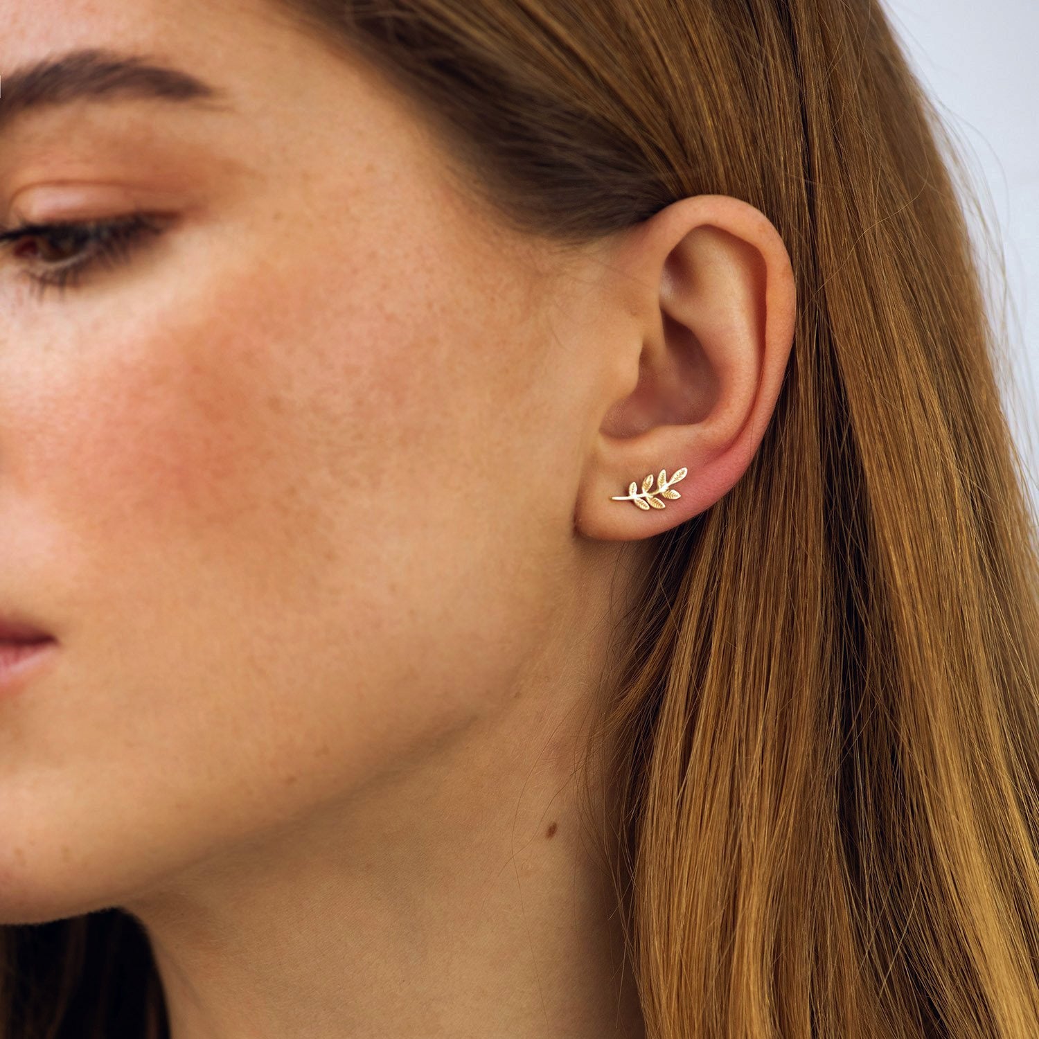 Close-up of a person wearing a gold leaf earring-solid gold earrings-Size: 13*6mm