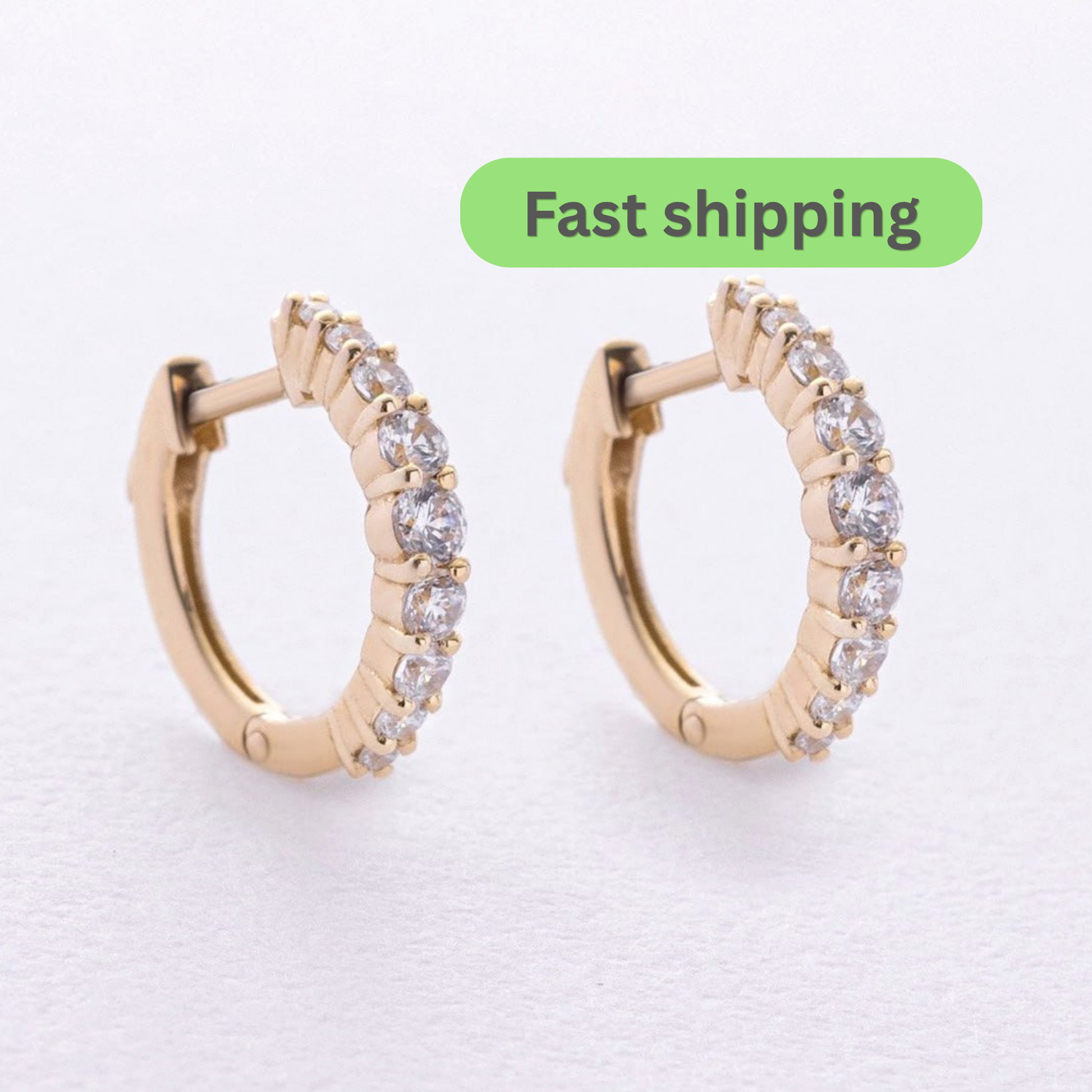A pair of gold hoop earrings with clear stones- solid 14k yellow gold, these hoops bring effortless femininity to any look, elegant or everyday.
