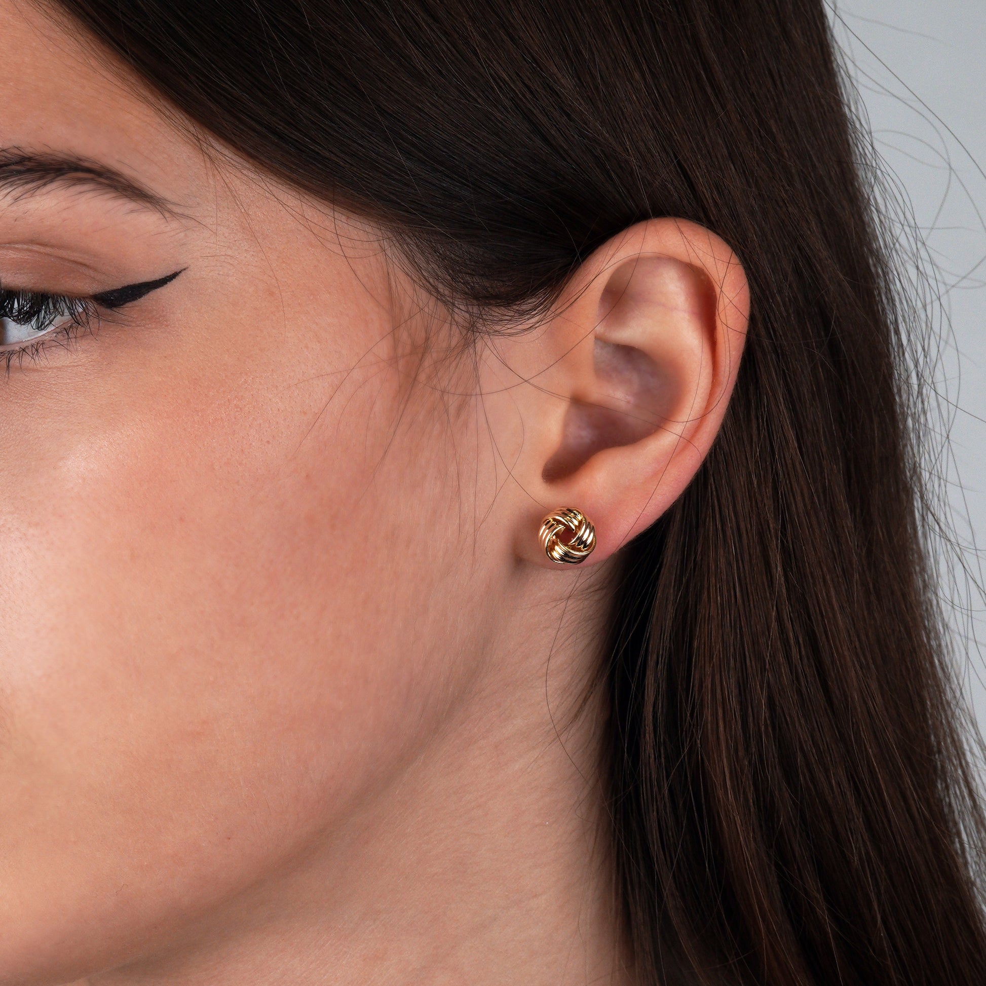 Close-up of a woman's ear wearing a gold earring -Weight: 1 -1.1 g-Lightweight, comfortable, and effortlessly chic