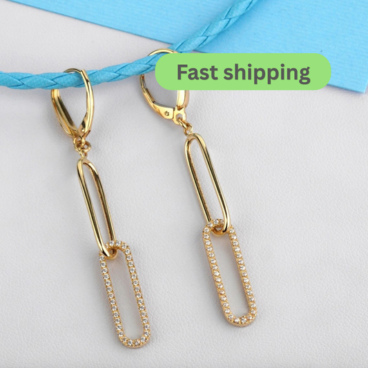 A pair of gold drop earrings with a paperclip design, featuring a clear rhinestone-studded center on the lower section-gold drop earrings-cz drop earrings-14k gold earrings