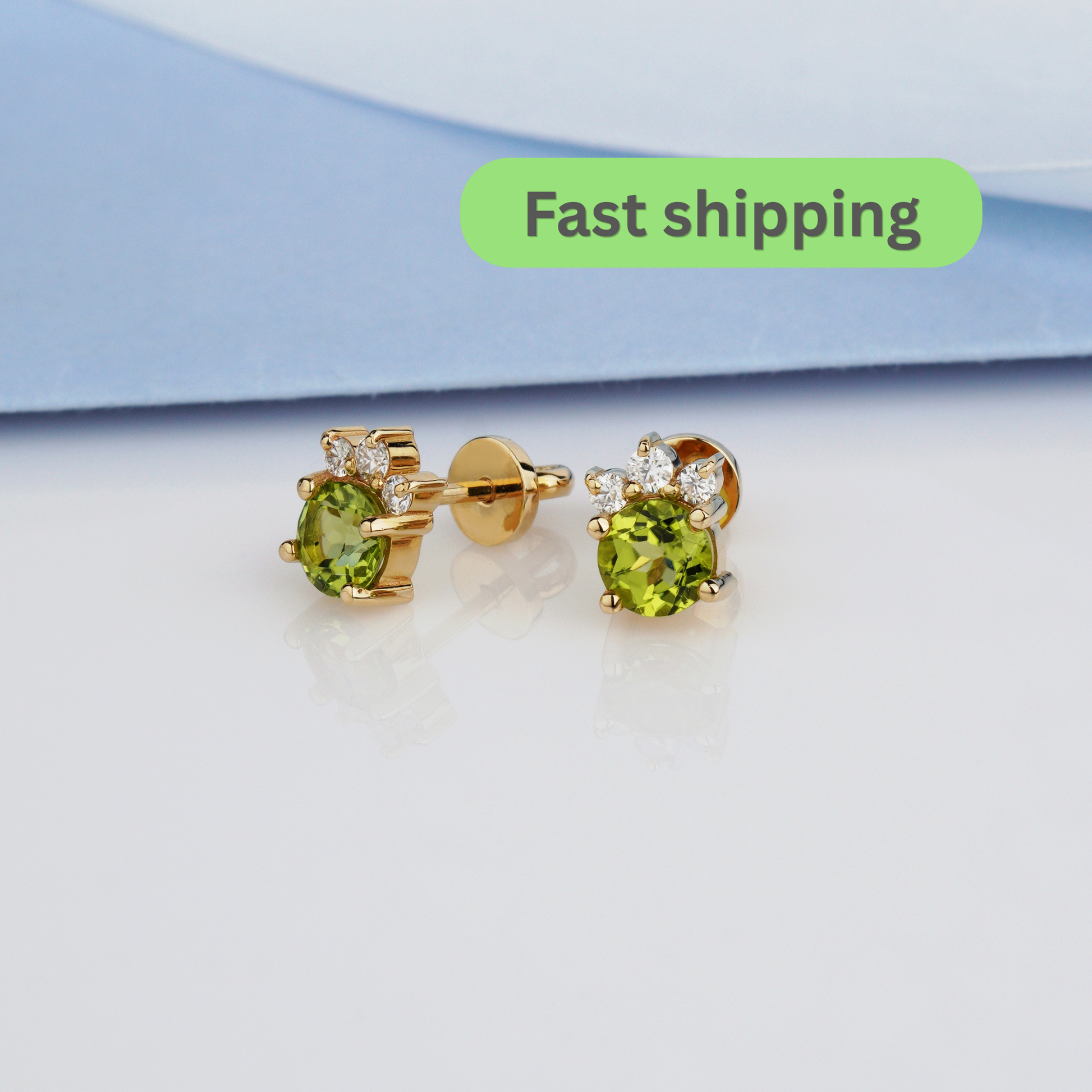 A pair of gold stud earrings with oval green gemstones and small clear accent stones-14k solid gold, 585 fineness-Stones: Peridot + Moissanites (0.15 ct)