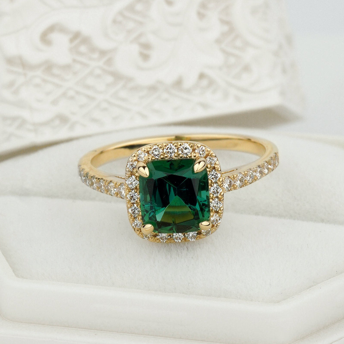 A gold ring with a square-cut green gemstone and sma green tourmaline ring
halo engagement ring
14k gold engagement ring
cushion cut ringll clear accent stones
