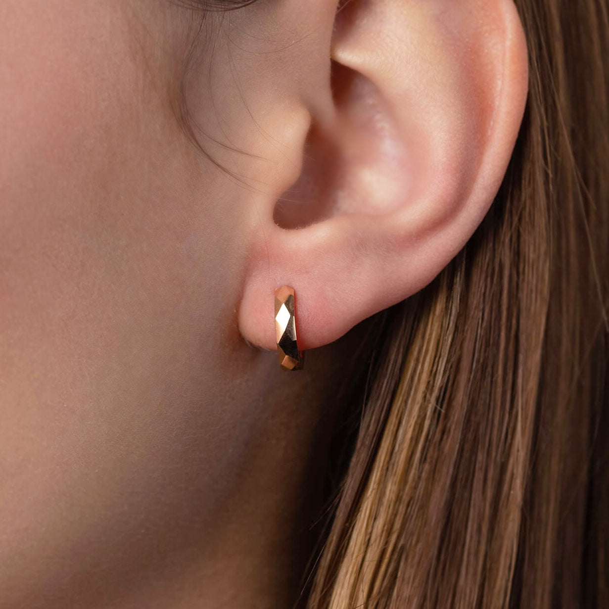Close-up of an ear wearing a rose gold hoop earring- Inner diameter: 11 mm-14k gold (rose or yellow)