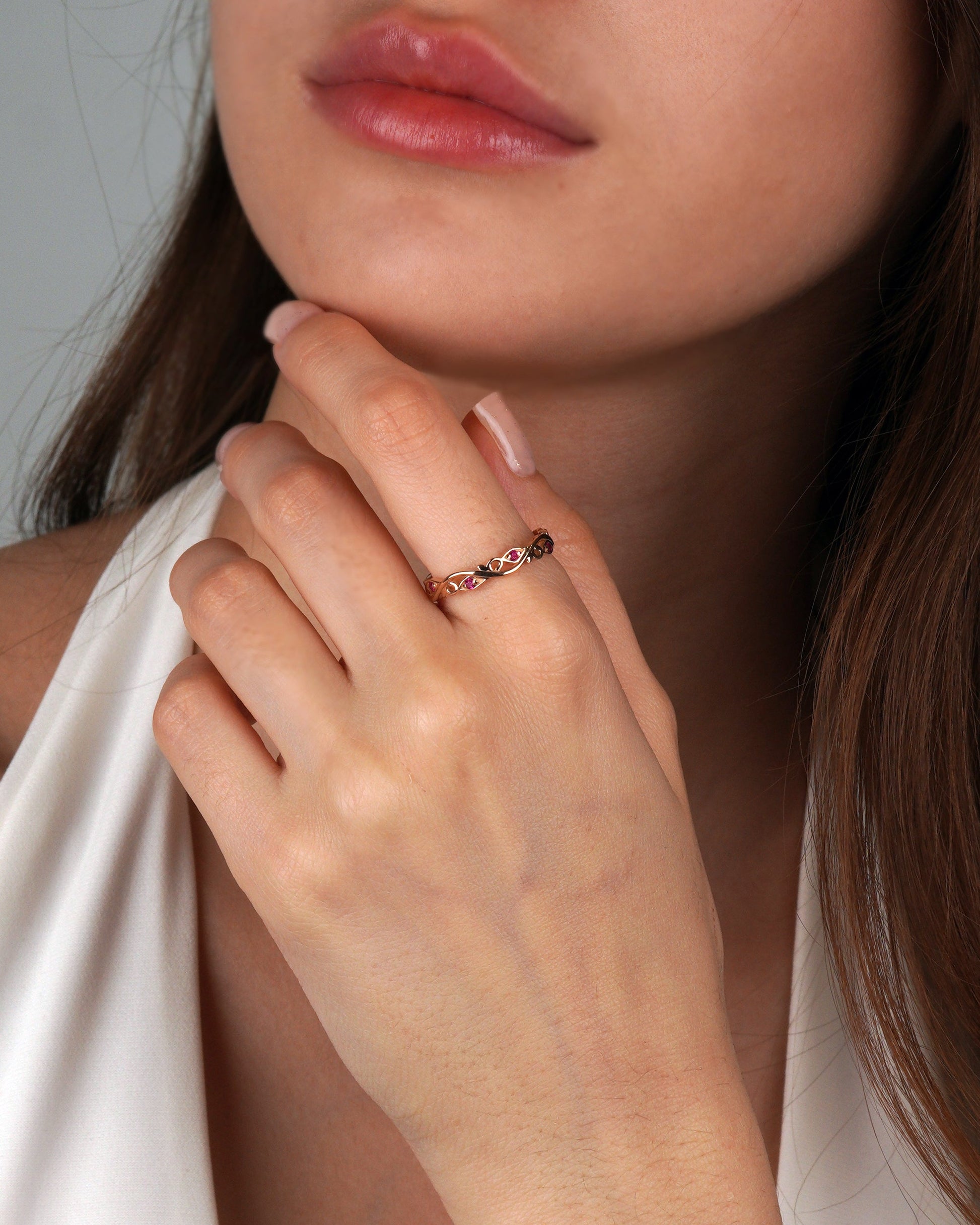 Close-up of a hand wearing a gold ring - 3.5 mm wide- natural rubies 0.12 ct