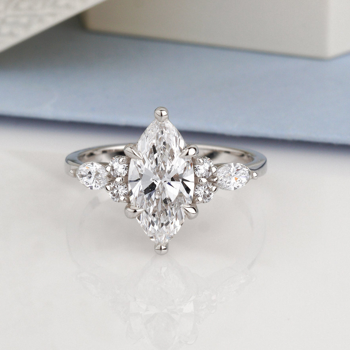 Metal: 14k White Gold (585), solid-Center Stone: Diamond, Marquise Cut, 1.5 ct VVS2/D, IGI Certified-Side Stones: Diamonds, 0.42 ct total (pear and round cluster)-marquise engagement ring-cluster engagement ring