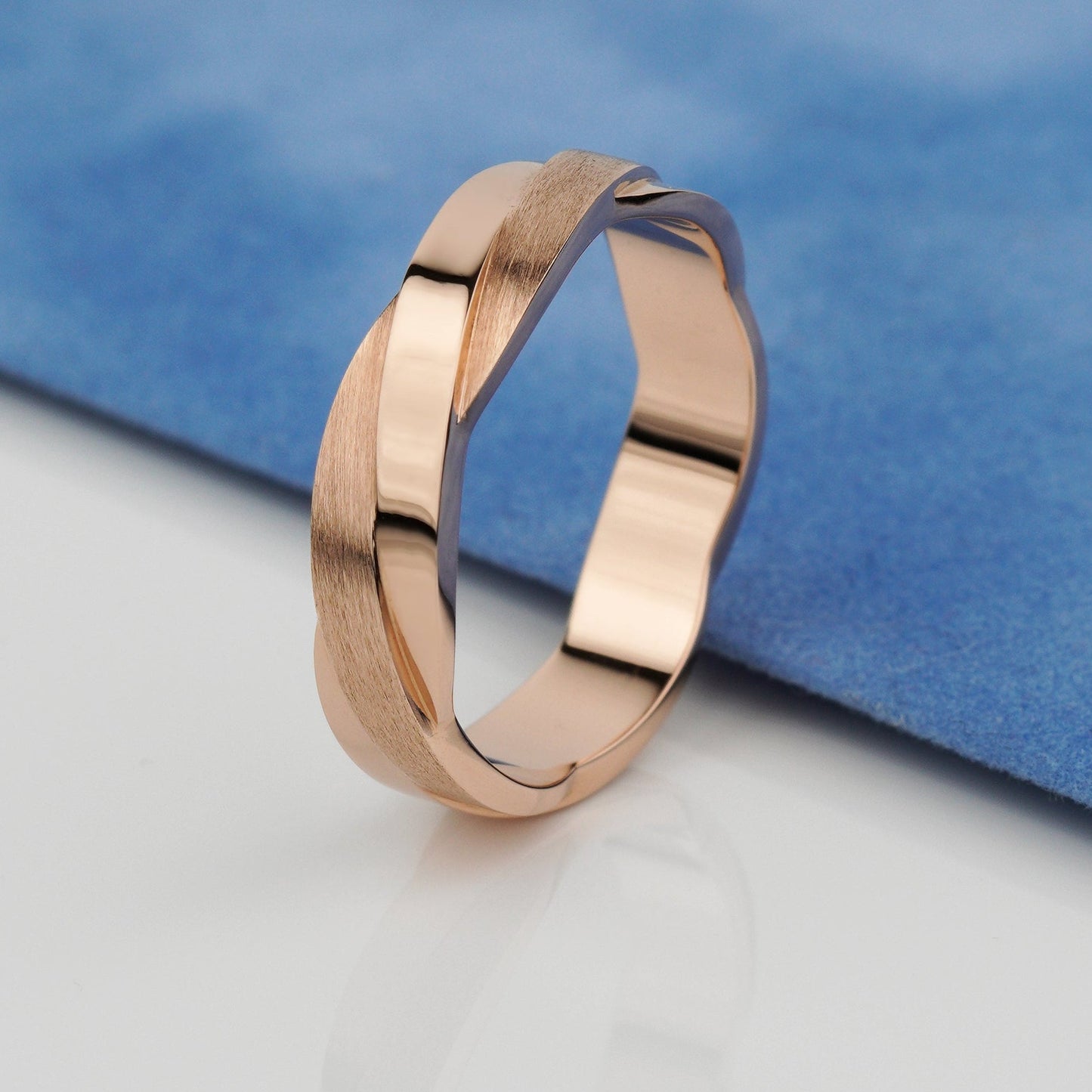 A polished rose gold band ring with a textured, brushed finish on one side and a smooth, reflective finish on the other- 14k solid gold-combination of matte and polished finish