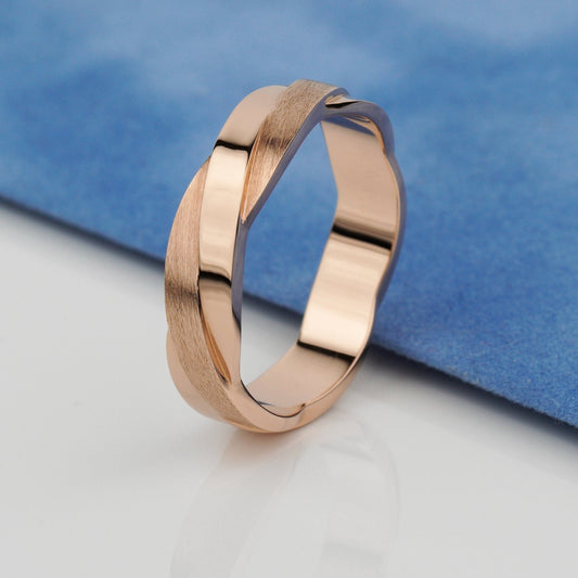 A polished rose gold band ring with a textured, brushed finish on one side and a smooth, reflective finish on the other- 14k solid gold-combination of matte and polished finish