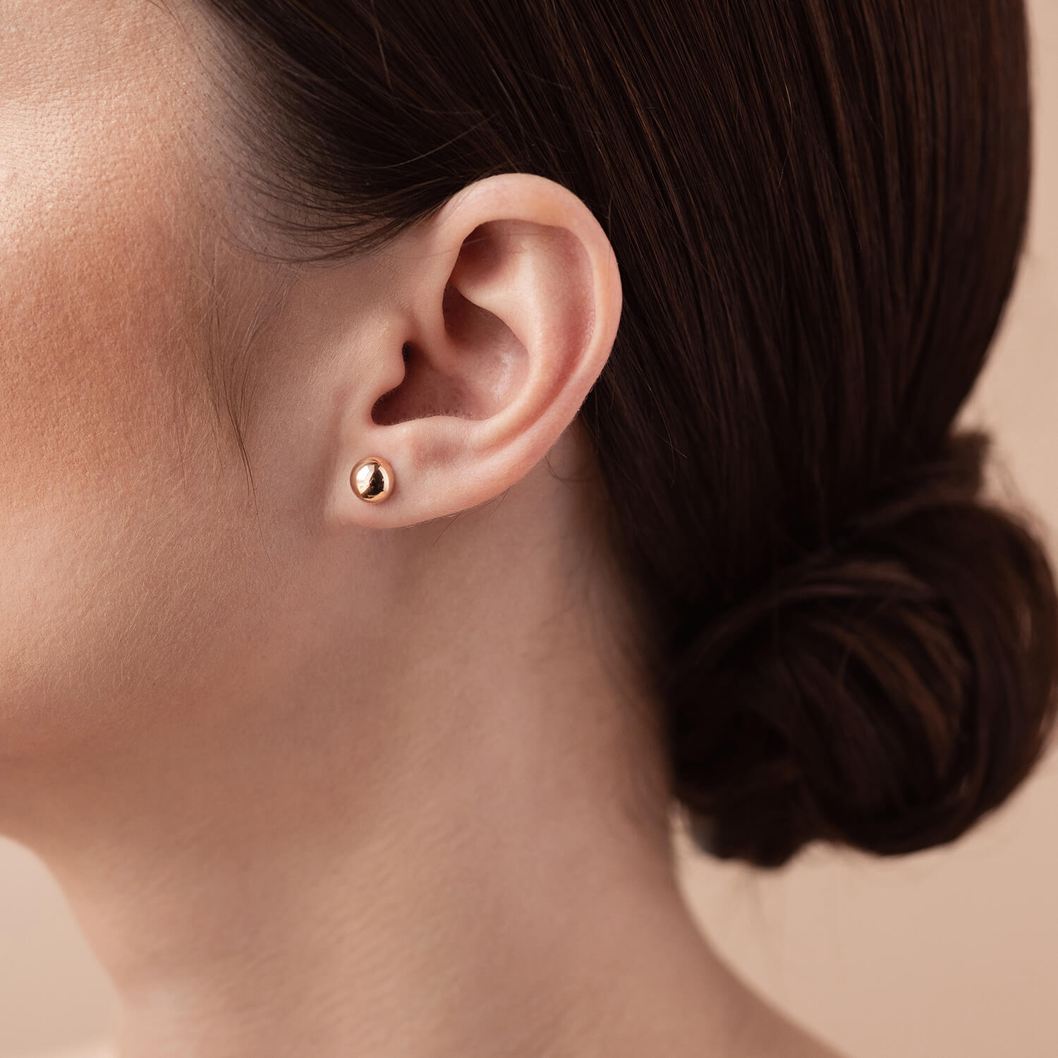 Close-up of polished 7mm gold ball stud earrings, fine jewelry detail shot-timeless gold studs