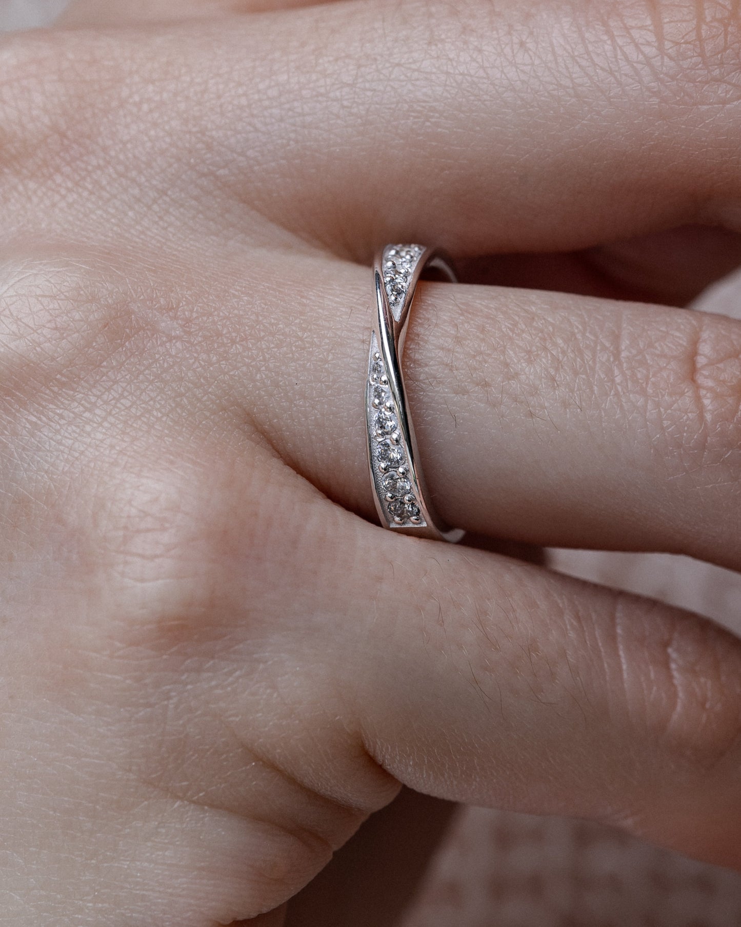 Close-up of a hand wearing a diamond ring - symbol of Infinite Love
