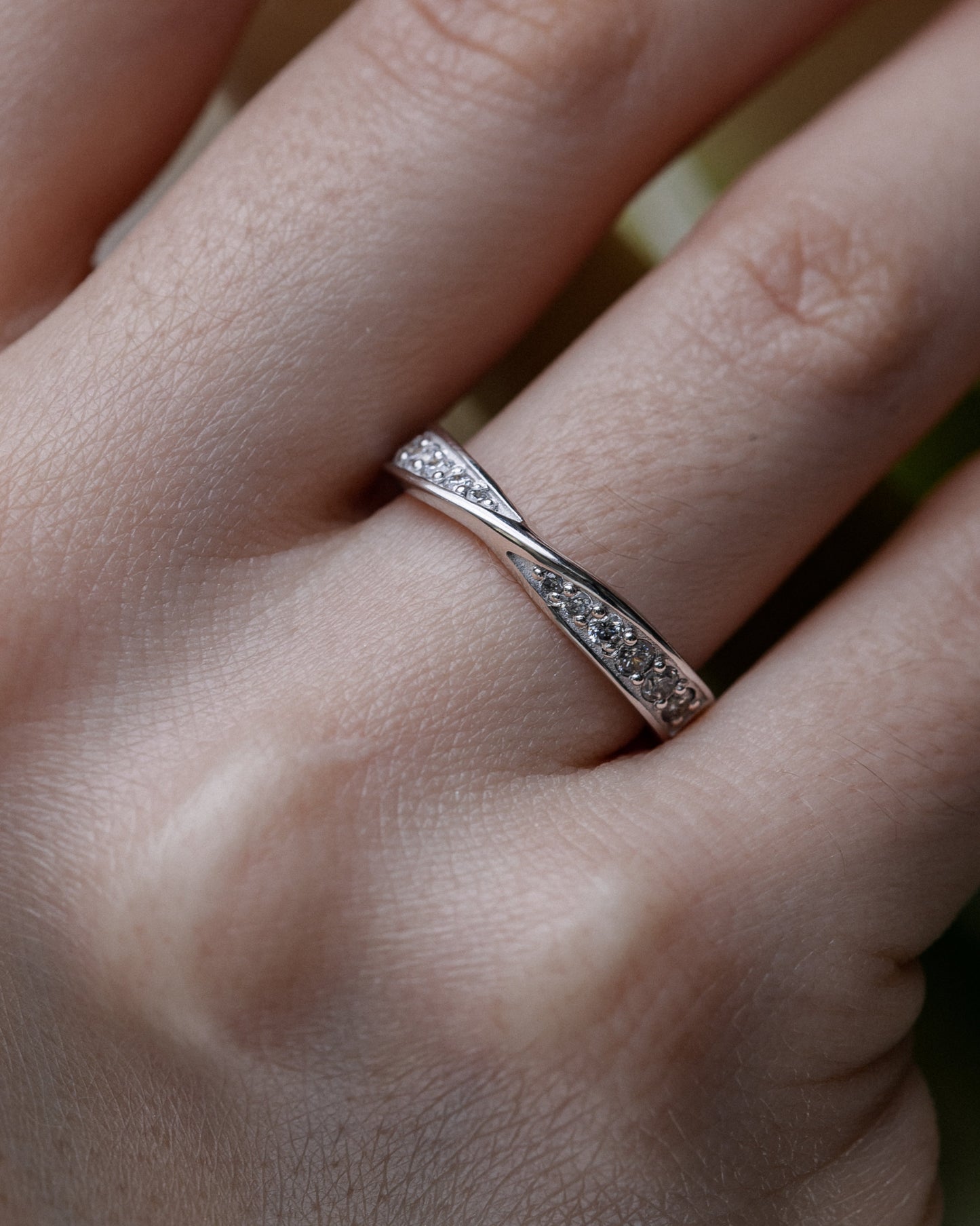 Close-up of a hand wearing a white gold ring with small diamonds-diamonds 0.22ct VVS2/f