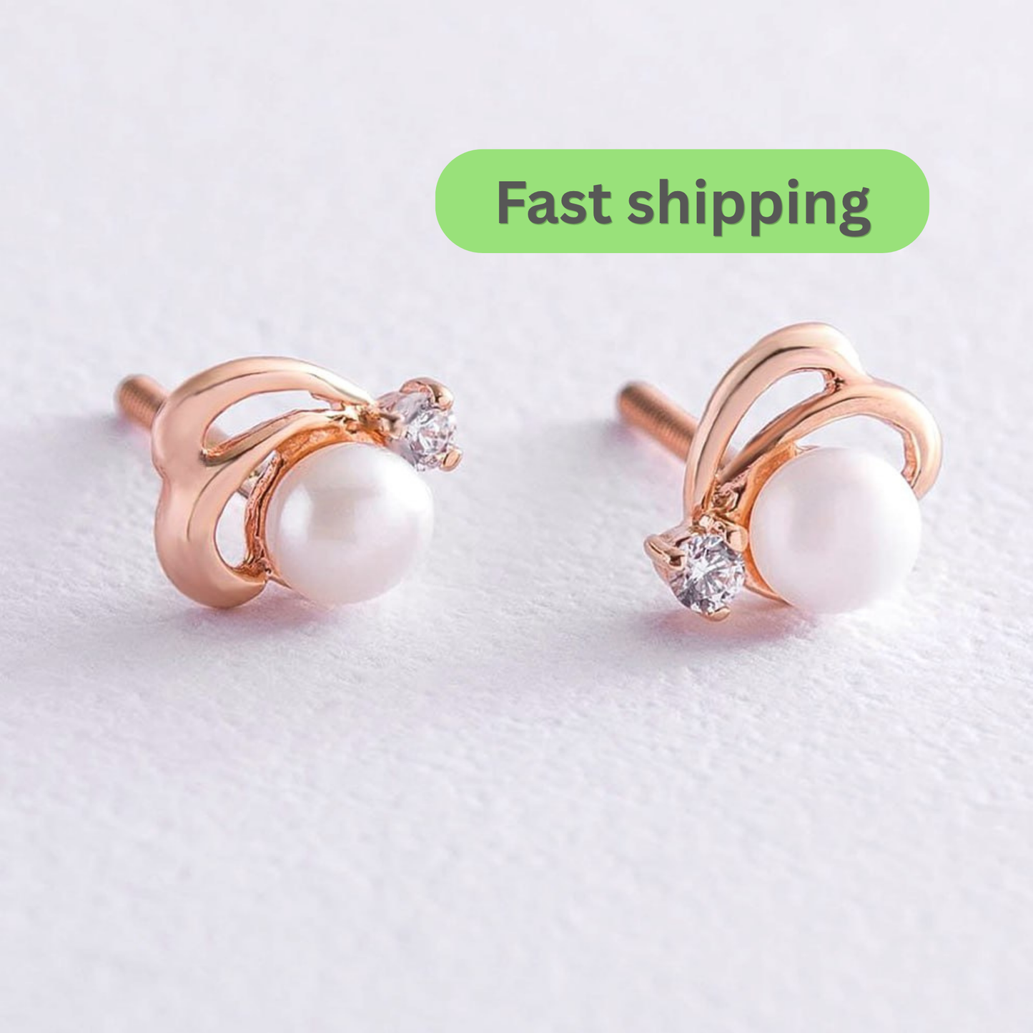 A pair of rose gold stud earrings with a white pearl and a small clear crystal accent-pearl stud earrings-rose gold earrings-14k gold pearl studs