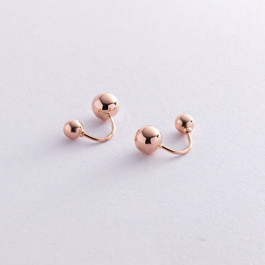 A pair of rose gold cartilage barbell earrings with small spherical beads-Material: 14k rose gold- Earring size: 18 mm