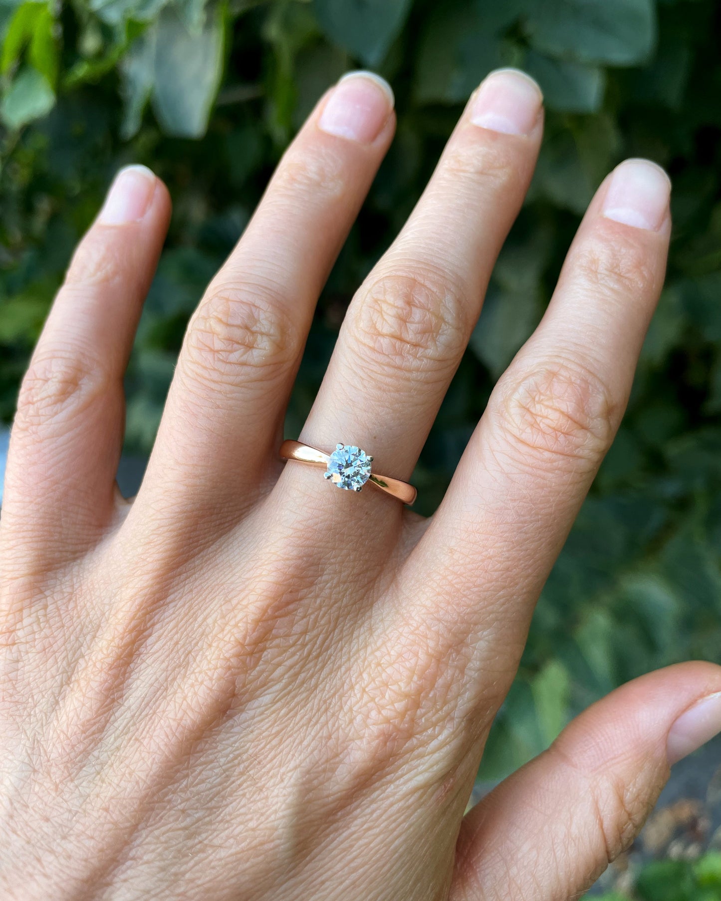 Hand wearing a rose gold ring with a diamond -IGI certified lab-grown diamond  0.5 ct, VVS2 / D color