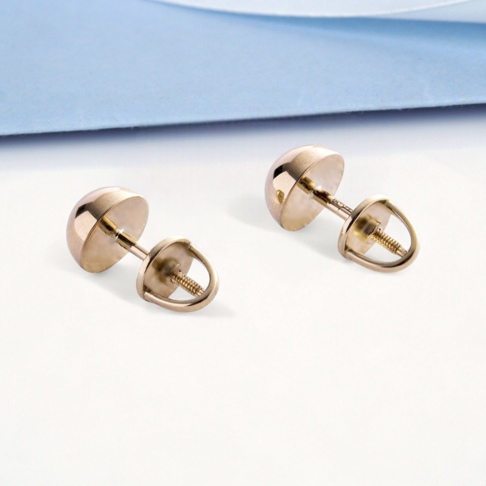Close-up of polished 7mm gold ball stud earrings, fine jewelry detail shot-classic ball stud earrings