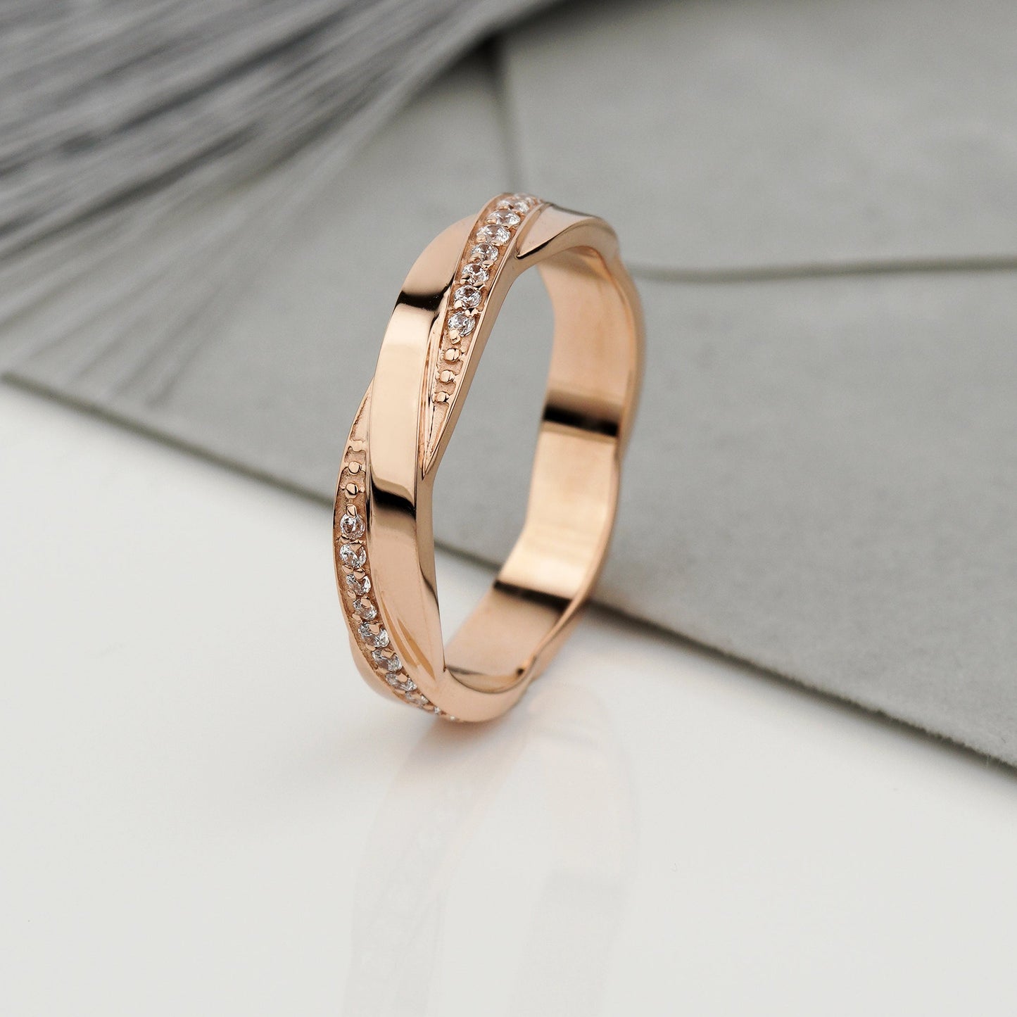 A rose gold band ring with a twisted design and a channel of small clear stones-rose gold wedding band -unique wedding ring -matte wedding band 