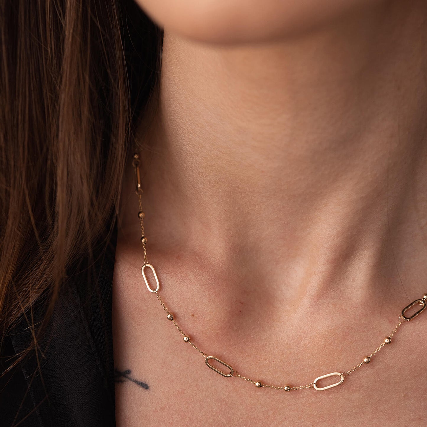  gold necklace on a person's neck- for everyday wear-lightweight, durable, and effortlessly chic neklace