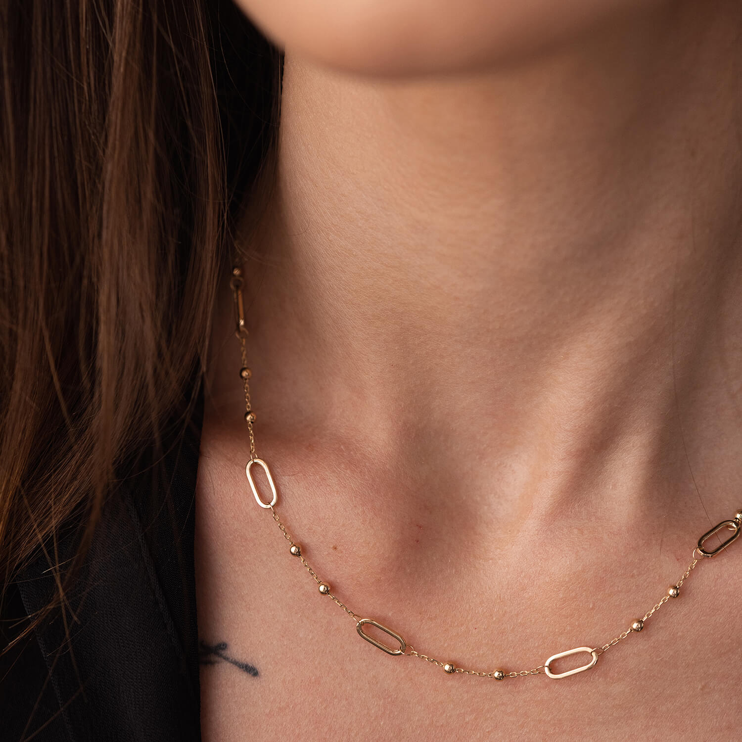  gold necklace on a person's neck- for everyday wear-lightweight, durable, and effortlessly chic neklace