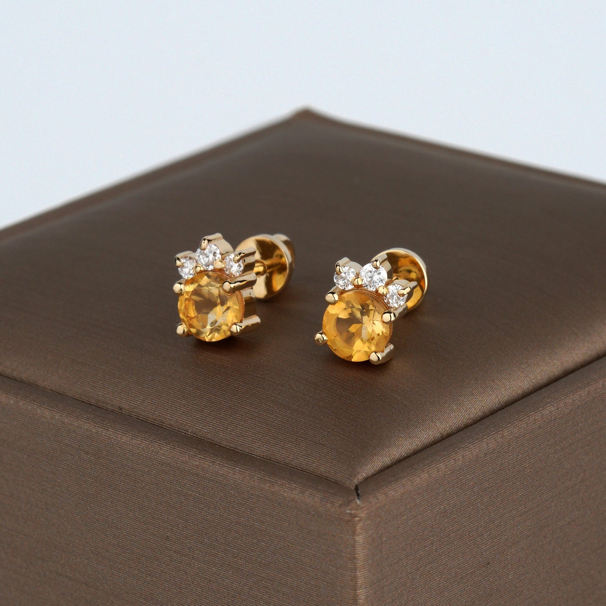 A pair of gold stud earrings with round yellow gemstones and small clear accent stones-Closure: stud (screw-back)-Weight: 2.3–2.5 g-Size: 8mm