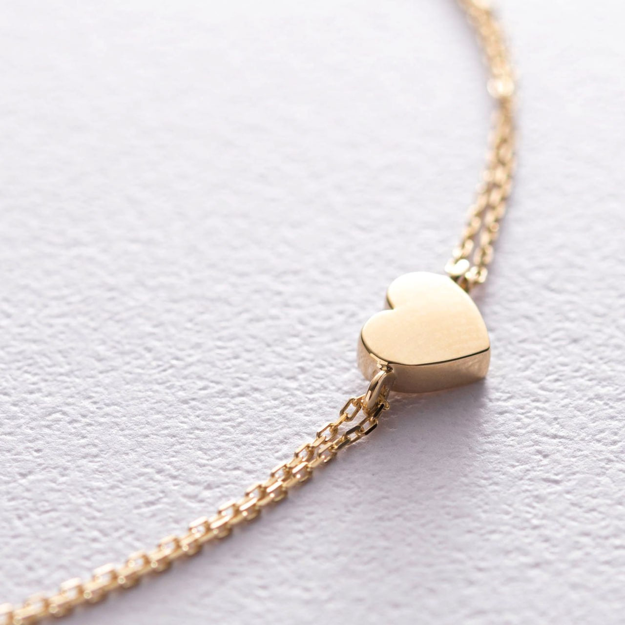 A delicate gold chain necklace featuring a small, polished gold heart charm-layered chain bracelet-solid gold bracelet-adjustable gold bracelet