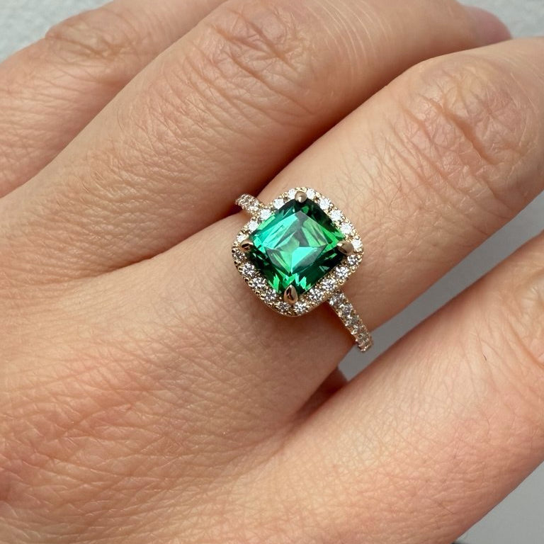 Center Stone: Natural Green Tourmaline, Cushion Cut, 1.7 ct
Accent Stones: Natural Diamonds, VVS2/F, 0.41 ct total
Setting: Diamond halo with pavé band
