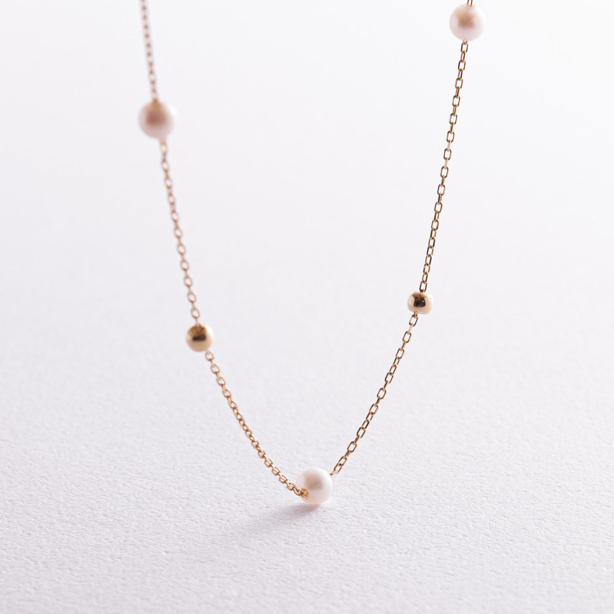 A delicate rose gold chain necklace featuring small, evenly spaced white pearl beads-dainty pearl necklace-minimalist gold necklace-delicate chain necklace