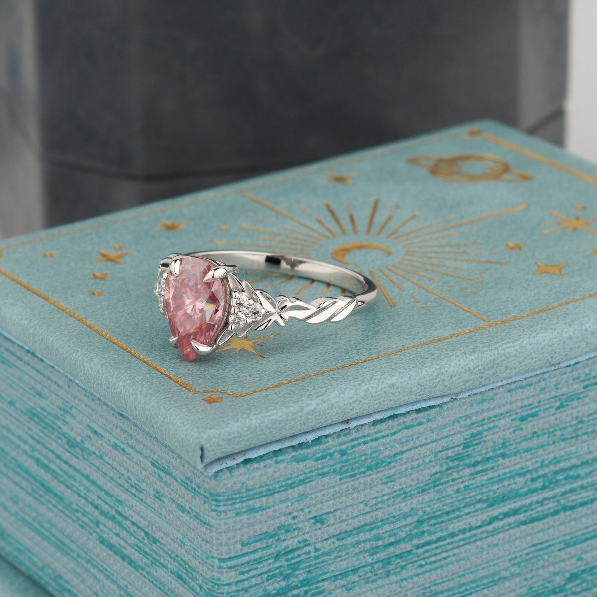 A white gold ring with a marquise-cut pink gemstone and decorative side details-custom engagement ring-pear shaped ring-pink stone engagement ring 