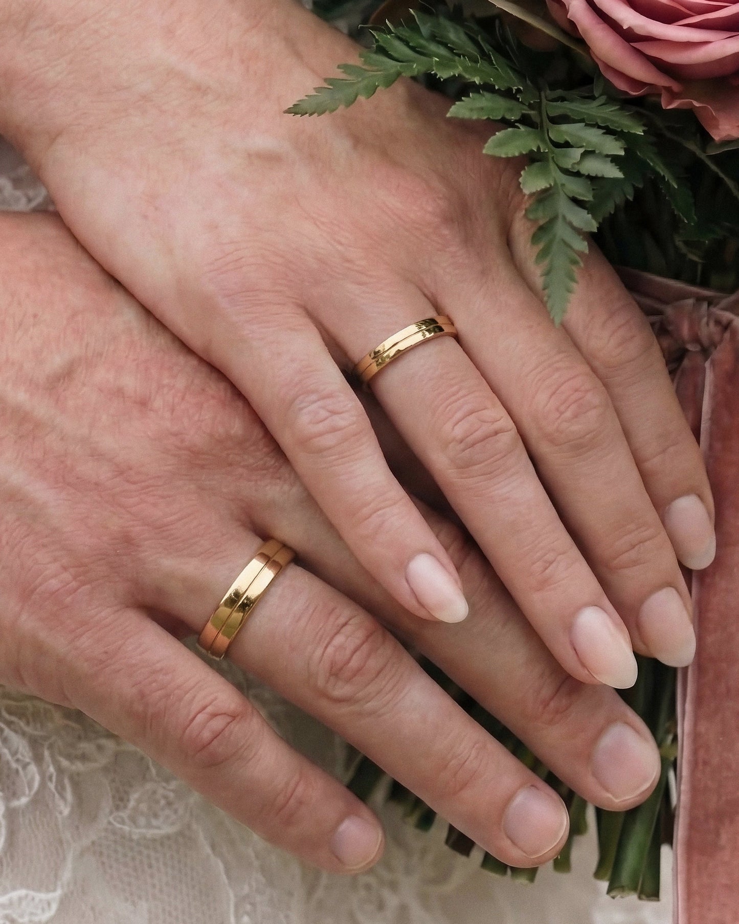 simple  wedding ring set on hands-flat profile with a subtle center-line detail- unique designer touch.