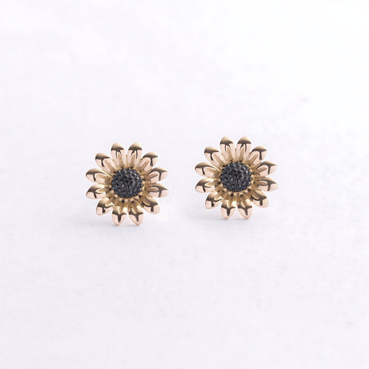 A pair of gold-toned daisy stud earrings with dark gray textured centers-flower stud earrings-flower gold earrings-minimalist gold earrings