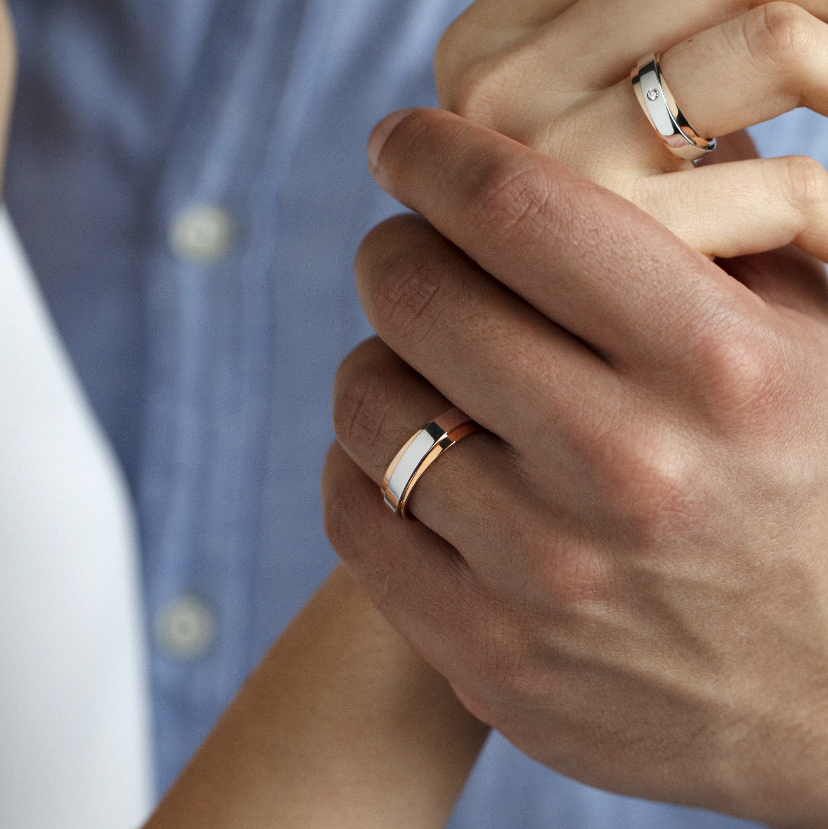 Close-up of two hands wearing slim metallic rings-6mm wide-available in 18k gold and platinum on request
