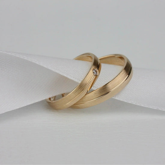 Classic gold wedding bands with diamond in her ring. Couple wedding bands. His and hers wedding rings set. Matching wedding bands.