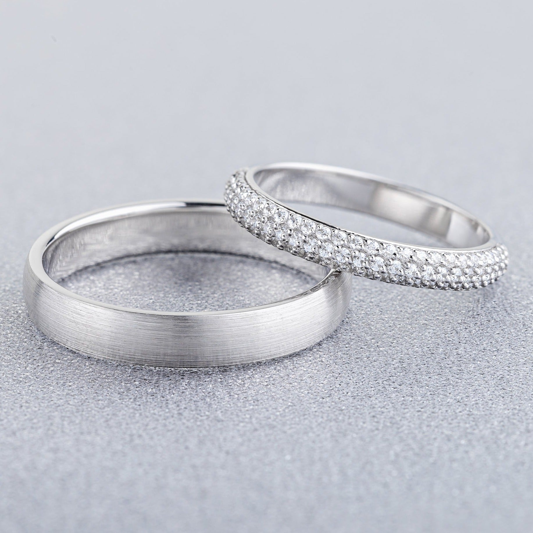 White gold wedding rings set with diamonds in her ring. His and hers wedding bands. Couple rings. Matching wedding rings set. Classic wedding bands with diamonds