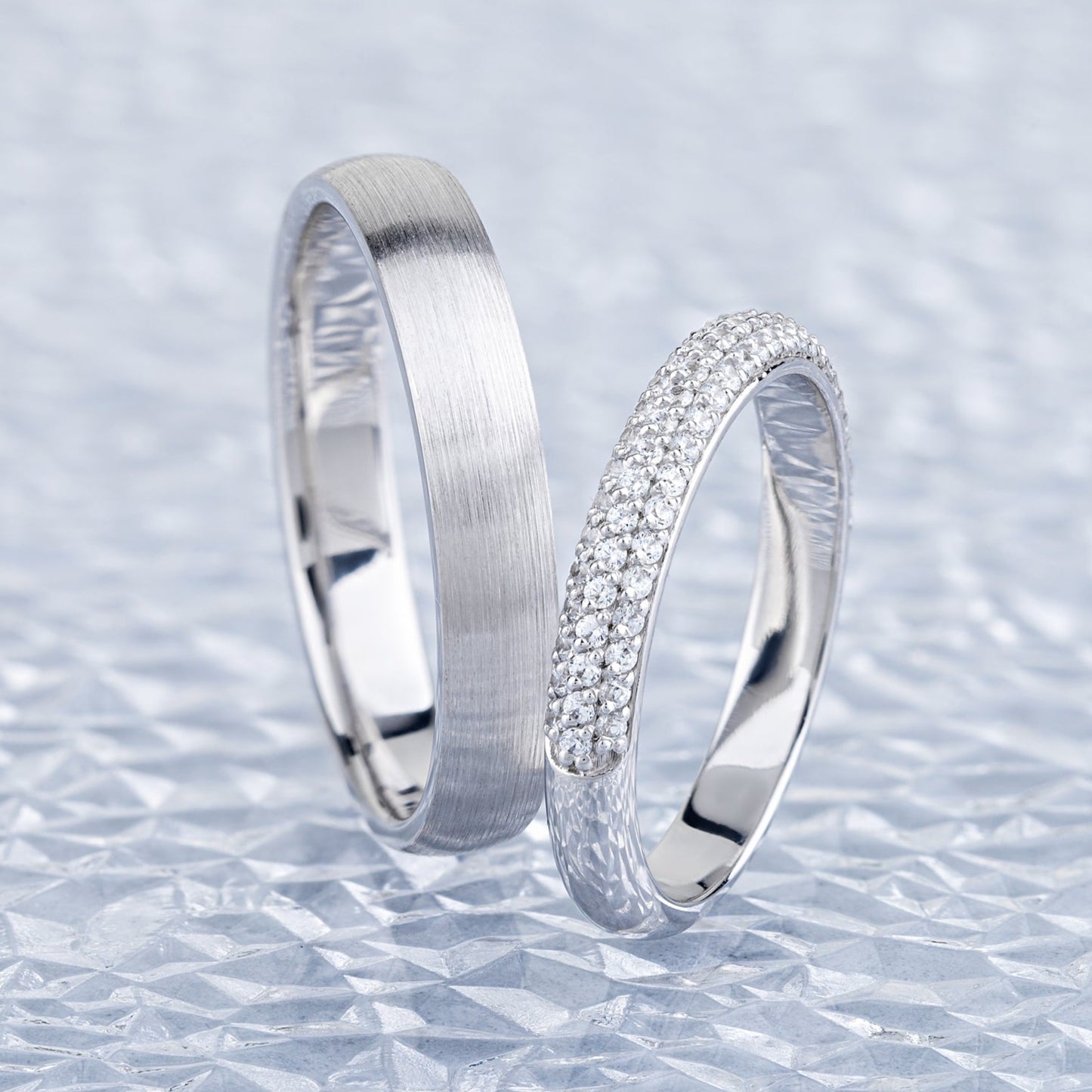 White gold wedding rings set with diamonds in her ring. His and hers wedding bands. Couple rings. Matching wedding rings set. Classic wedding bands with diamonds